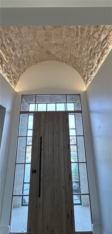 entryway with a wealth of natural light and lofted ceiling