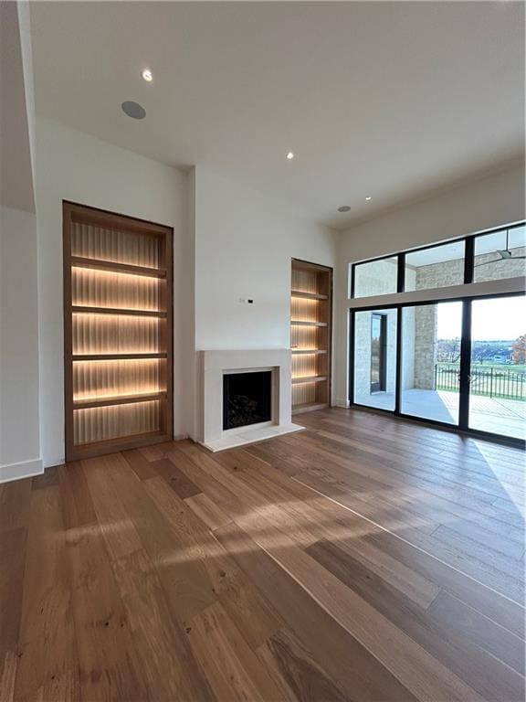 unfurnished living room featuring wood-type flooring