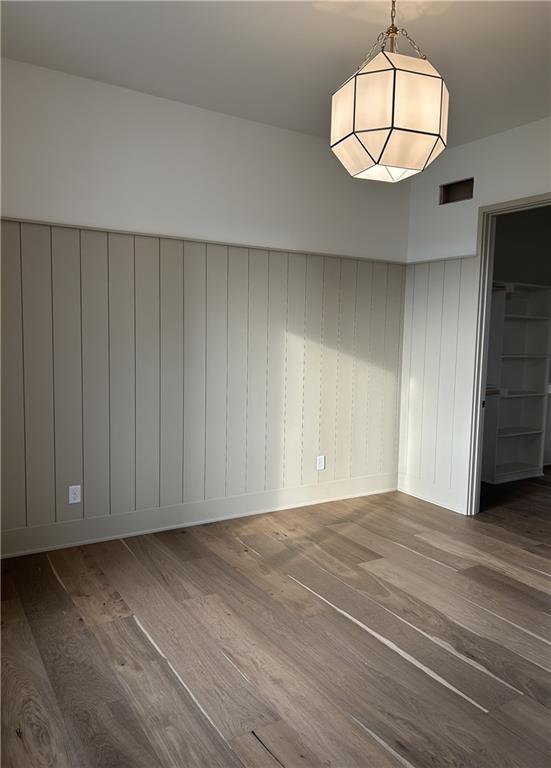 spare room featuring wood-type flooring