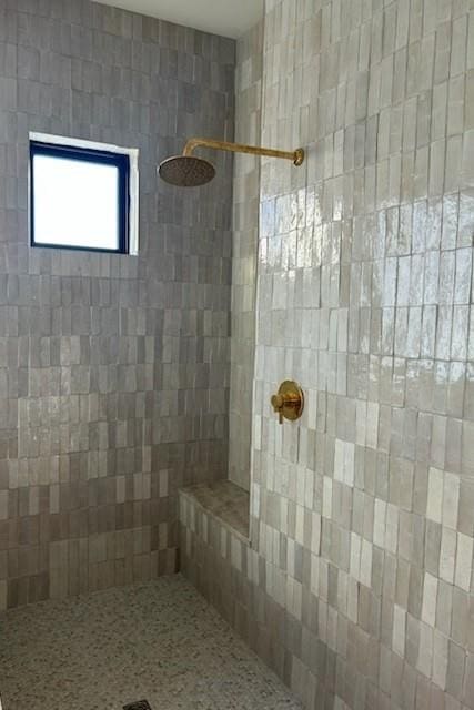 bathroom with tiled shower