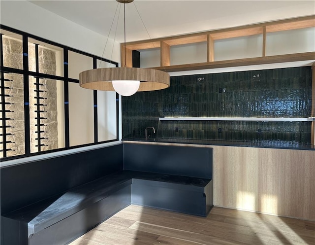 interior space with decorative backsplash and hardwood / wood-style flooring