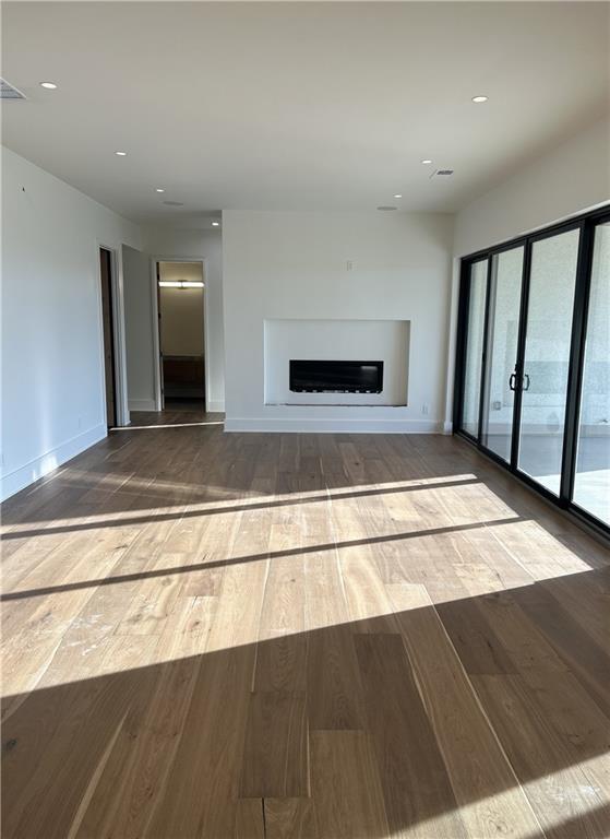 unfurnished living room featuring hardwood / wood-style flooring