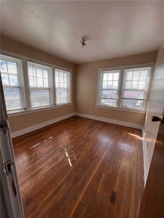 spare room with dark hardwood / wood-style flooring