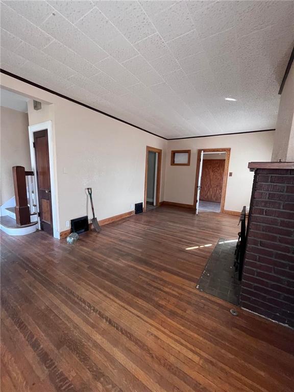 unfurnished living room with dark hardwood / wood-style flooring