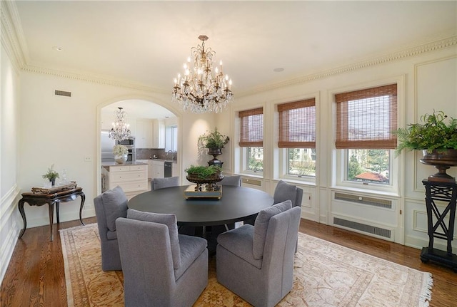 dining room featuring ornamental molding and hardwood / wood-style floors