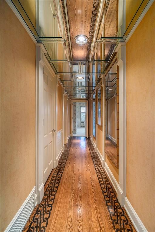 hall featuring ornamental molding, hardwood / wood-style flooring, and a baseboard radiator