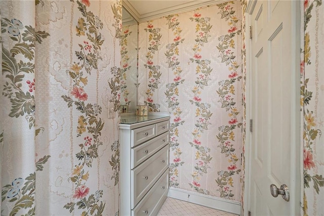 bathroom with crown molding, tile patterned flooring, and vanity