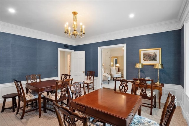 dining room with crown molding and an inviting chandelier