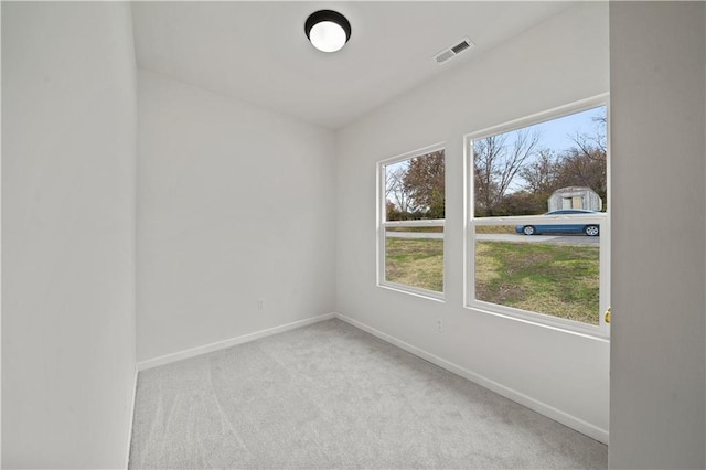 unfurnished room with light colored carpet