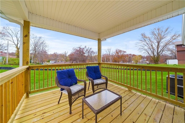 wooden deck featuring central AC and a lawn