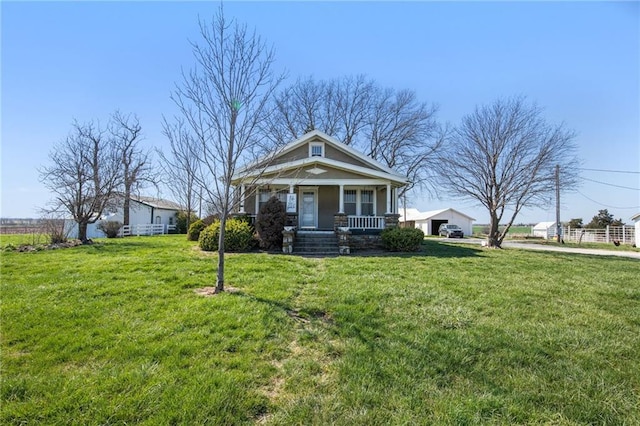 view of front facade with covered porch and a front lawn