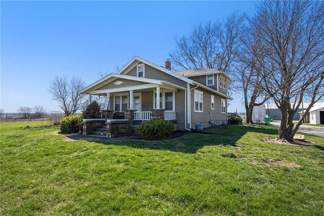 view of front of house with a porch and a front lawn