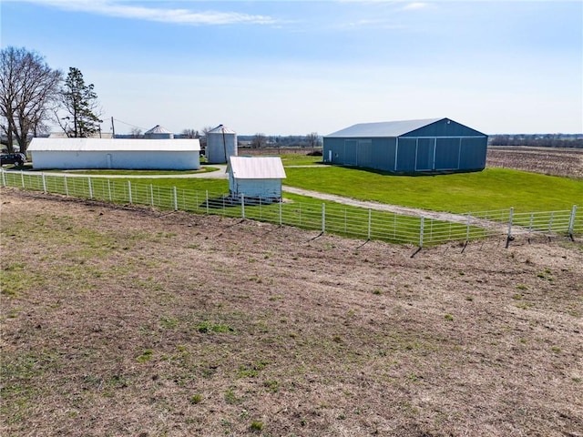 view of yard featuring an outbuilding and a rural view