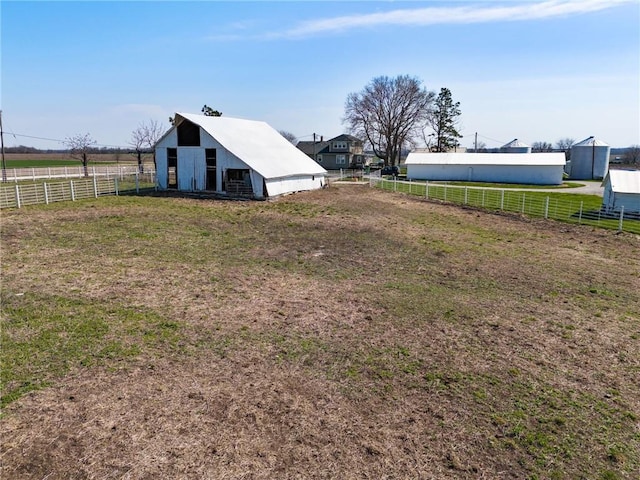 view of yard featuring an outbuilding and a rural view