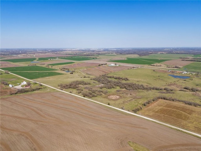 birds eye view of property with a rural view