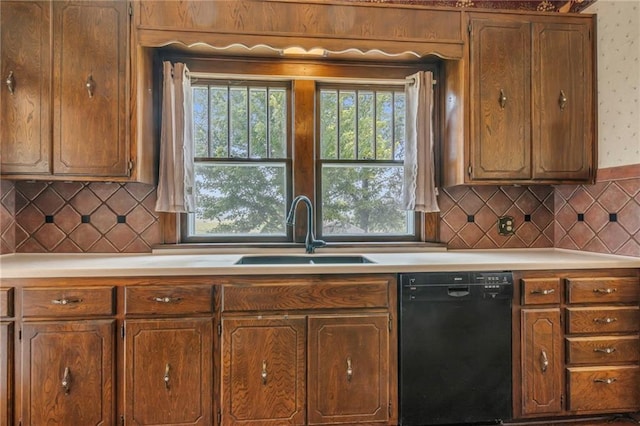 kitchen featuring black dishwasher, tasteful backsplash, and sink