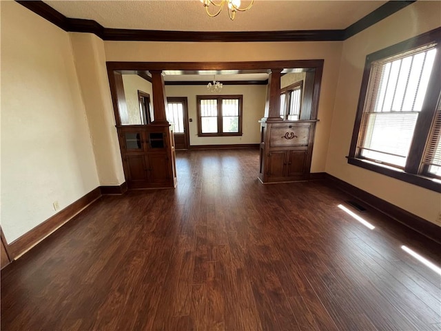 interior space with crown molding, a notable chandelier, and dark hardwood / wood-style floors