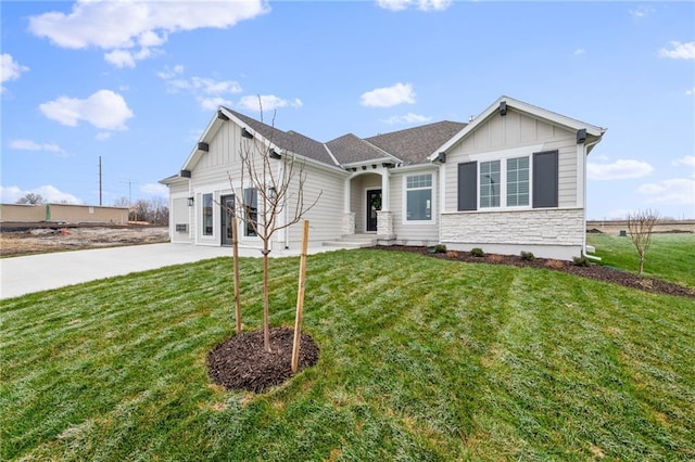 view of front of property with a front yard and a garage