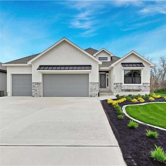 view of front of home with a front lawn and a garage