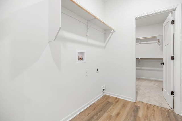 laundry room featuring washer hookup, light wood-style flooring, electric dryer hookup, laundry area, and baseboards