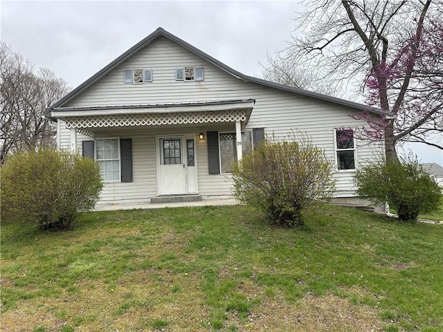 rear view of property featuring a yard