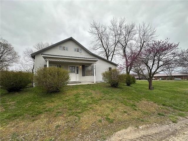 back of property featuring a yard