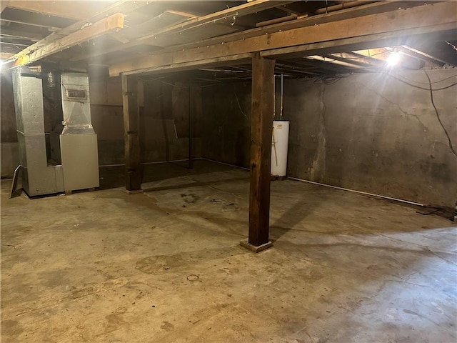 basement featuring heating unit and water heater