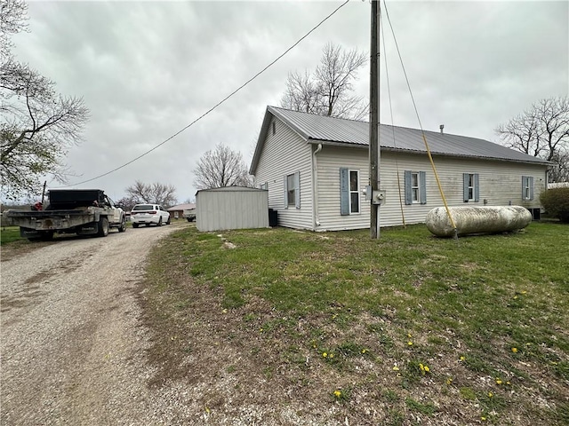 exterior space with a yard and a storage unit