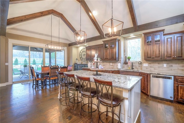 kitchen featuring stainless steel dishwasher, dark hardwood / wood-style floors, a center island with sink, and backsplash