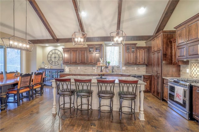 kitchen with double oven range, decorative light fixtures, and a center island