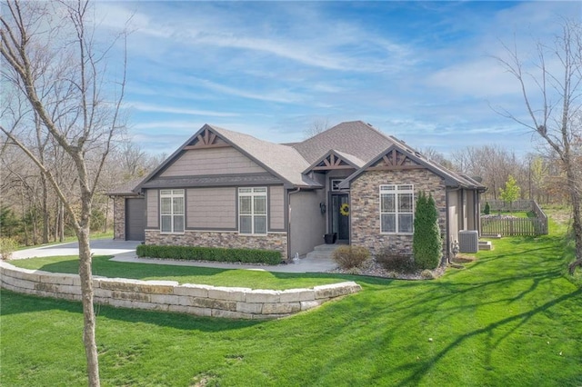 craftsman-style house featuring a garage, cooling unit, and a front lawn