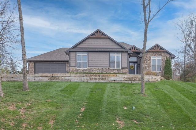 view of front of home with a garage and a front lawn