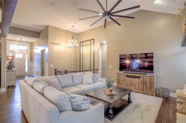 living room with vaulted ceiling, dark hardwood / wood-style floors, and a chandelier