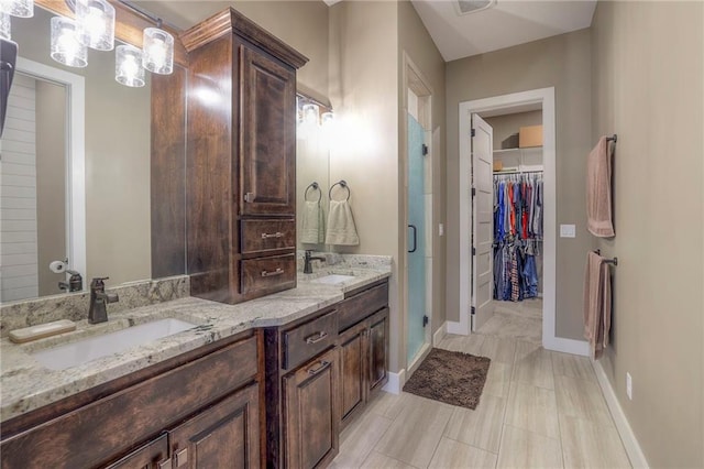 bathroom with vanity and a shower with shower door