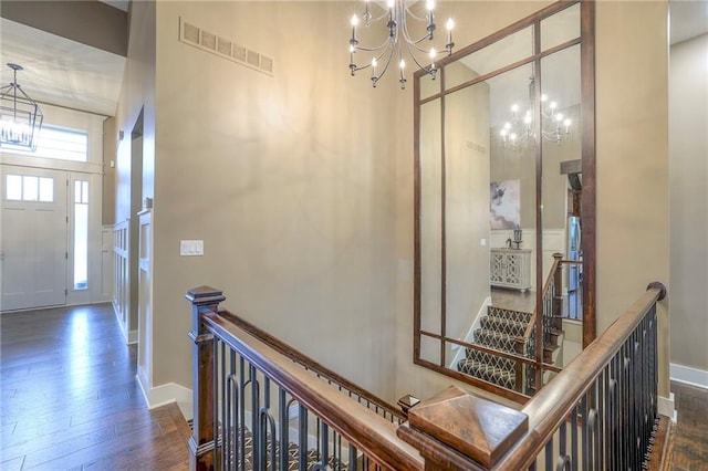 foyer with an inviting chandelier and dark hardwood / wood-style floors