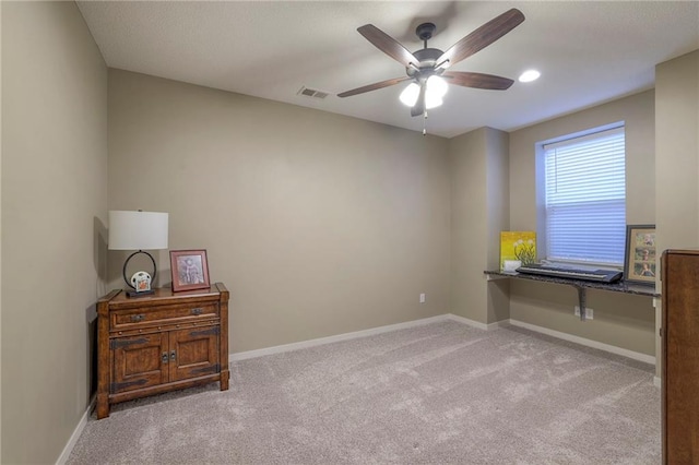 interior space featuring light colored carpet and ceiling fan