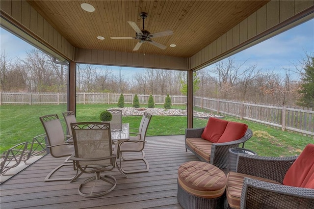 wooden deck with ceiling fan and a lawn