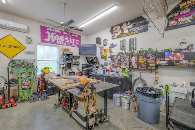 interior space featuring ceiling fan, a workshop area, and a wall mounted AC