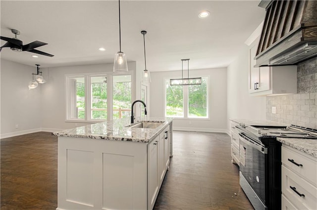 16615 NW 124th St, Platte City, MO 64079 - kitchen featuring stainless steel range oven, wall chimney exhaust hood, tasteful backsplash, dark wood-style flooring, and a ceiling fan