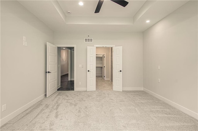 16615 NW 124th St, Platte City, MO 64079 - unfurnished bedroom with a tray ceiling, recessed lighting, light carpet, a spacious closet, and a ceiling fan