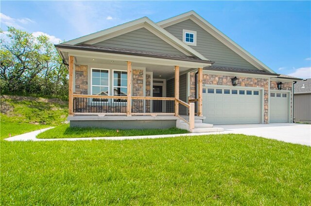 16615 NW 124th St, Platte City, MO 64079 - view of front of home with covered porch, stone siding, concrete driveway, and a front lawn