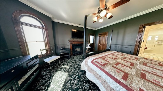 carpeted bedroom with ceiling fan, connected bathroom, and ornamental molding