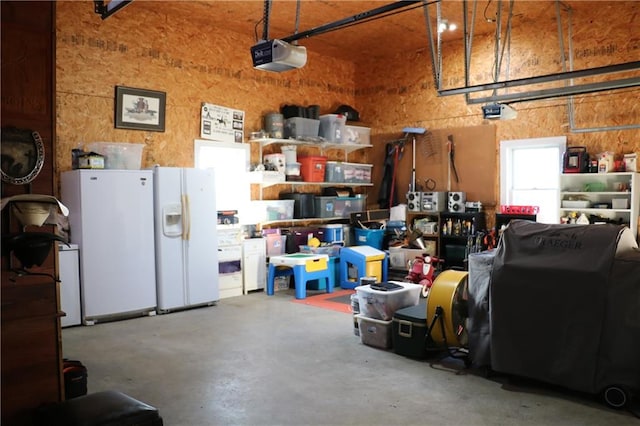 garage with white fridge with ice dispenser, white refrigerator, and a garage door opener