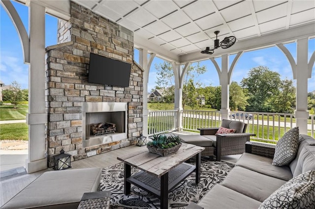 view of patio / terrace with an outdoor living space with a fireplace