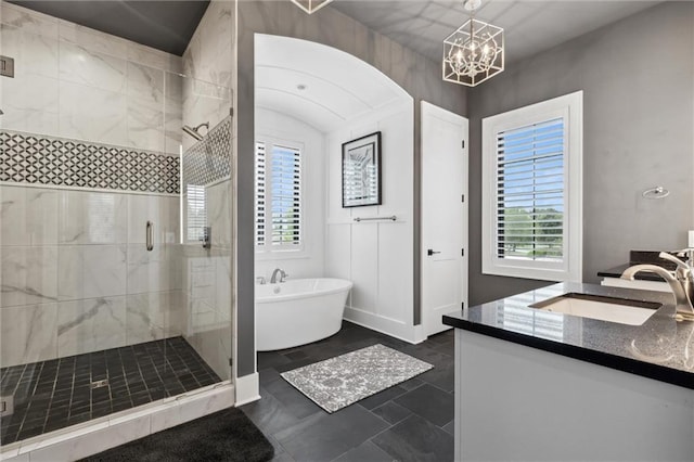 bathroom featuring plus walk in shower, tile patterned flooring, a chandelier, and vanity