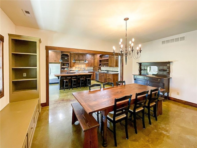 dining area with built in shelves and a chandelier