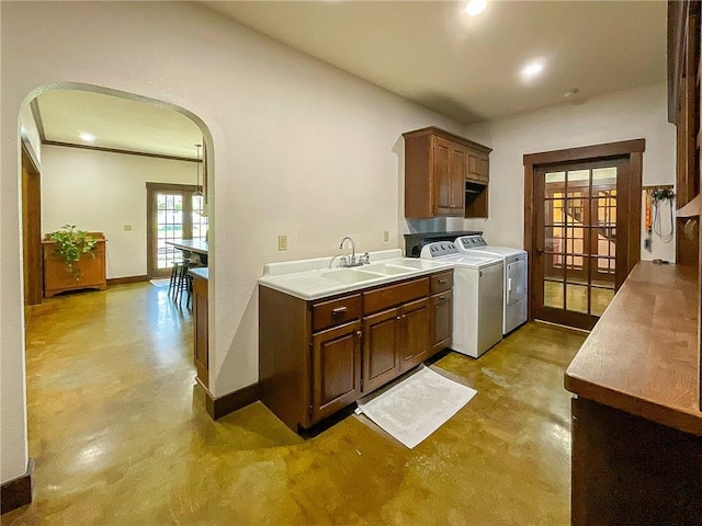 kitchen with washer and clothes dryer, french doors, and sink