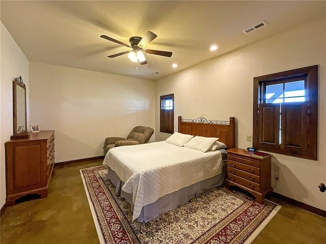 bedroom with ceiling fan and dark carpet