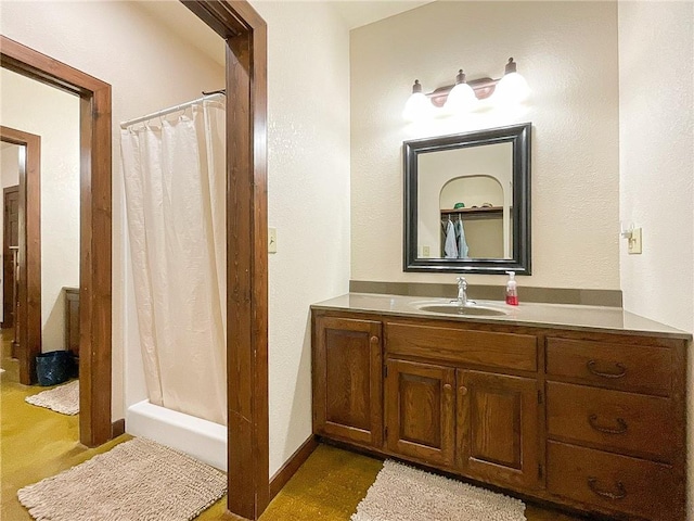 bathroom with a shower with curtain and vanity