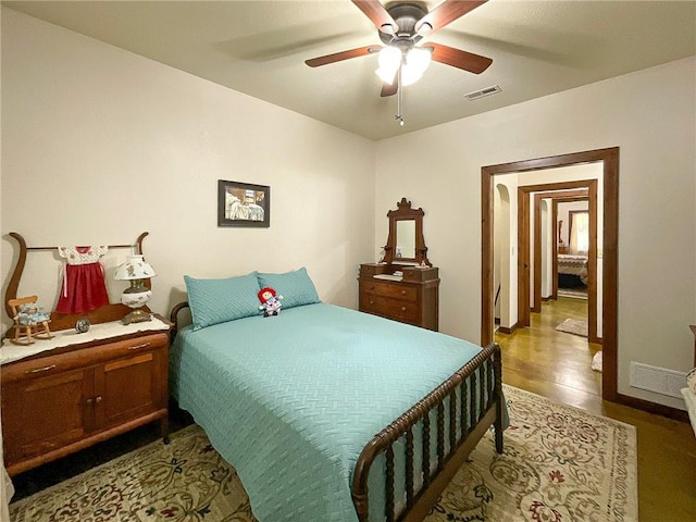 bedroom with wood-type flooring and ceiling fan